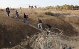 Palestinian laborers cross illegally into Israeli areas through a hole in Israel's security barrier on November 20, 2019, near the southern Israeli city of Beersheba. (HAZEM BADER / AFP)