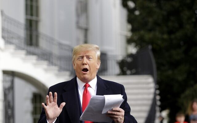 US President Donald Trump reads from his notes as he talks to the media on the South Lawn of the White House before boarding Marine One in Washington, DC, November 20, 2019, en route to Austin, Texas. (Joshua Lott / AFP) US President Donald Trump reads from his notes as he talks to the media on the South Lawn of the White House before boarding Marine One in Washington, DC, November 20, 2019, en route to Austin, Texas. (Joshua Lott / AFP)