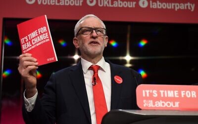 Britain's opposition Labour Party leader Jeremy Corbyn holds up a copy of the party's manifesto, as he speaks during the launch of the Labour party election manifesto in Birmingham, northwest England, November 21, 2019. (Oli Scarff/AFP)