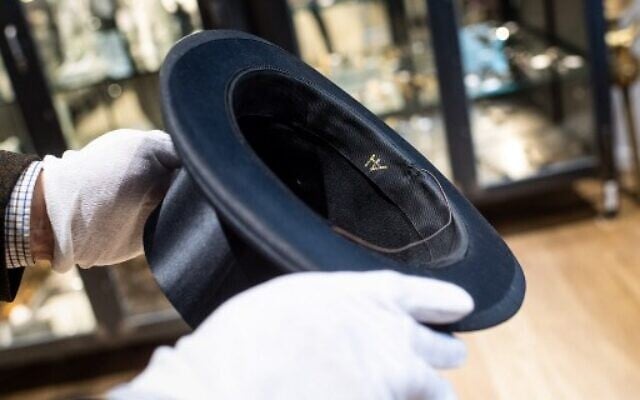 This file photo taken on November 20, 2019 shows a man holding a top hat with the initials "AH" from the J A Seidl hat manufacturer on November 20, 2019 in Grasbrunn near Munich, southern Germany, prior to an auction of personal belongings from German dictator Adolf Hitler and other notorious World War II Nazi leaders. (Photo by Matthias Balk / dpa / AFP) ) This file photo taken on November 20, 2019 shows a man holding a top hat with the initials "AH" from the J A Seidl hat manufacturer on November 20, 2019 in Grasbrunn near Munich, southern Germany, prior to an auction of personal belongings from German dictator Adolf Hitler and other notorious World War II Nazi leaders. (Photo by Matthias Balk / dpa / AFP) )