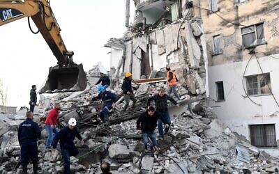 Emergency workers clear debris at a damaged building in Thumane, 34 kilometers northwest of capital Tirana, after an earthquake hit Albania, on November 26, 2019. (Gent SHKULLAKU / AFP)