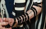Andor Stern’s concentration camp tattoo is seen despite his tefillin straps. (Courtesy of the Sao Paulo Holocaust Memorial via JTA)