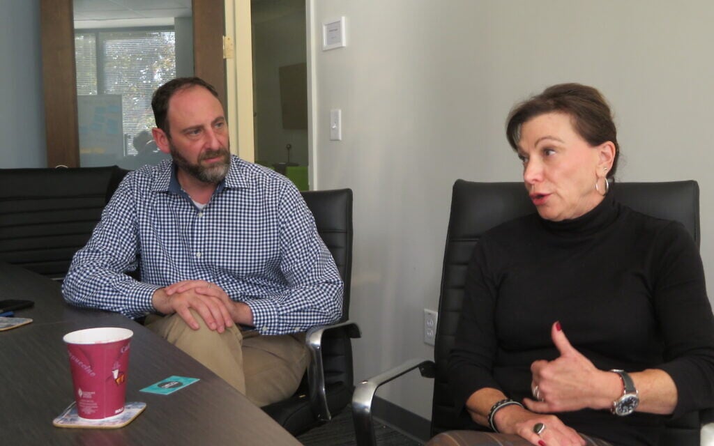 Andrew Lewis listens to Abbie Fuksman during a discussion about the city's Jewish community ahead of the 2020 elections held at the Atlanta offices of the American Jewish Committee, November 21, 2019. (Ron Kampeas/JTA)