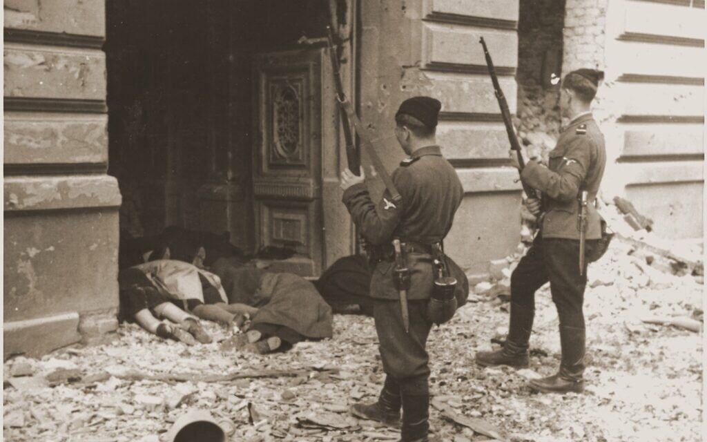 Askari or Trawniki guards peer into a doorway past the bodies of Jews killed during the suppression of the Warsaw Ghetto Uprising. (Courtesy of US Holocaust Memorial Museum) Askari or Trawniki guards peer into a doorway past the bodies of Jews killed during the suppression of the Warsaw Ghetto Uprising. (Courtesy of US Holocaust Memorial Museum)