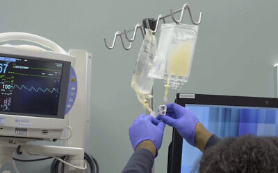 In this January 2019 image made from video provided by Penn Medicine, IV bags of CRISPR-edited T cells are prepared for administering to a patient at the Abramson Cancer Center in Philadelphia. (Penn Medicine via AP)