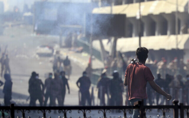 Iraqi riot police fire tear gas to disperse anti-government protesters gathering on bridge in central Baghdad, Iraq, November 9, 2019. (AP Photo/Hadi Mizban) Iraqi riot police fire tear gas to disperse anti-government protesters gathering on bridge in central Baghdad, Iraq, November 9, 2019. (AP Photo/Hadi Mizban)