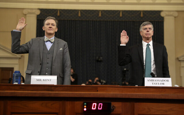 Career Foreign Service officer George Kent, left, and top US diplomat in Ukraine William Taylor, right, are sworn in to testify during the first public impeachment hearing of US President Donald Trump by the House Intelligence Committee on Capitol Hill, in Washington, November 13, 2019. (Andrew Harnik/AP) Career Foreign Service officer George Kent, left, and top US diplomat in Ukraine William Taylor, right, are sworn in to testify during the first public impeachment hearing of US President Donald Trump by the House Intelligence Committee on Capitol Hill, in Washington, November 13, 2019. (Andrew Harnik/AP)