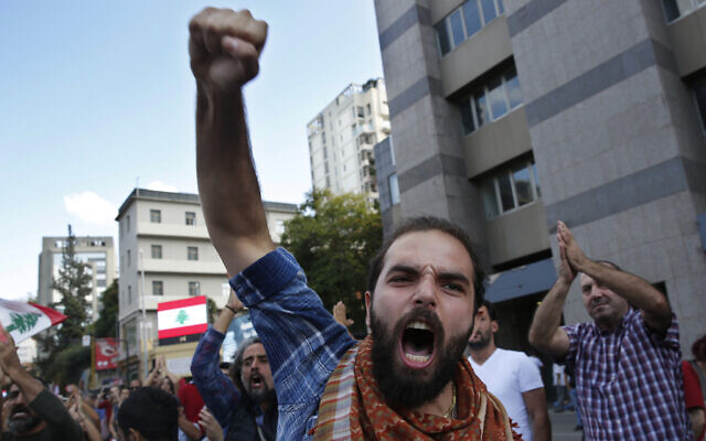 In this October 29, 2019 file photo, an anti-government protester shouts slogans after he is attacked by Hezbollah supporters, in Beirut, Lebanon. (AP Photo/Hussein Malla, File) In this October 29, 2019 file photo, an anti-government protester shouts slogans after he is attacked by Hezbollah supporters, in Beirut, Lebanon. (AP Photo/Hussein Malla, File)