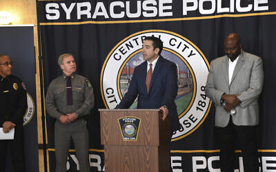 Peter Fitzgerald from the FBI addresses questions about a series of racist messages and hate crimes that have occurred at SU in the last two weeks during a press conference Tuesday, Nov. 19, 2019, at the Public Safety Building in Syracuse, N.Y. On the far left is Syracuse University DPS Chief Bobby Maldonado. Next to him is Major Philip Rougeux, Troop D Commander for the New York State Police. At right is Syracuse Police Chief Kenton Buckner. (Lauren Long/The Syracuse Newspapers via AP)