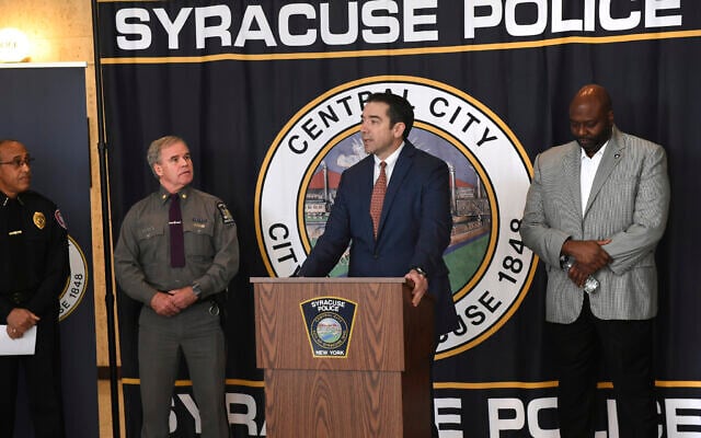 Peter Fitzgerald from the FBI addresses questions about a series of racist messages and hate crimes that have occurred at SU in the last two weeks during a press conference Tuesday, Nov. 19, 2019, at the Public Safety Building in Syracuse, N.Y. On the far left is Syracuse University DPS Chief Bobby Maldonado. Next to him is Major Philip Rougeux, Troop D Commander for the New York State Police. At right is Syracuse Police Chief Kenton Buckner. (Lauren Long/The Syracuse Newspapers via AP) Peter Fitzgerald from the FBI addresses questions about a series of racist messages and hate crimes that have occurred at SU in the last two weeks during a press conference Tuesday, Nov. 19, 2019, at the Public Safety Building in Syracuse, N.Y. On the far left is Syracuse University DPS Chief Bobby Maldonado. Next to him is Major Philip Rougeux, Troop D Commander for the New York State Police. At right is Syracuse Police Chief Kenton Buckner. (Lauren Long/The Syracuse Newspapers via AP)