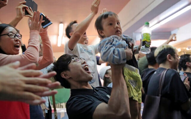 Pro-democracy supporters celebrate after pro-Beijing politician Junius Ho lost his election in Hong Kong, November 25, 2019. (AP Photo/Kin Cheung) Pro-democracy supporters celebrate after pro-Beijing politician Junius Ho lost his election in Hong Kong, November 25, 2019. (AP Photo/Kin Cheung)