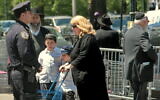 Illustrative: A police officer patrols a mostly the ultra-Orthodox Jewish section of the Crown Heights neighborhood of Brooklyn, New York, May 23, 2008. (Bebeto Matthews/AP)