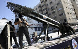 Palestinian members of the Al-Quds Brigades, the military wing of the Islamic Jihad terrorist group, parade with a replica rocket on a truck during a march to show loyalty for the Iranian-backed Palestinian movement's newly-elected leader Ziad al-Nakhalah during a rally along the streets of Gaza, Thursday, Oct. 4, 2018. (AP Photo/Adel Hana)