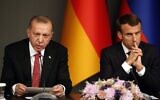 Turkey's President Recep Tayyip Erdogan, left, sits by French President Emmanuel Macron during a news conference following a summit on Syria, in Istanbul, Saturday, Oct. 27, 2018. (AP Photo/Lefteris Pitarakis)