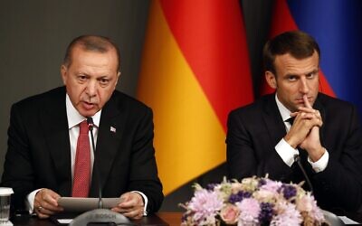 Turkey's President Recep Tayyip Erdogan, left, sits by French President Emmanuel Macron during a news conference following a summit on Syria, in Istanbul, Saturday, Oct. 27, 2018. (AP Photo/Lefteris Pitarakis)