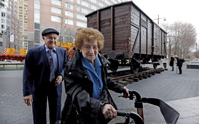 Holocaust survivors Leon Kaner, age 94, and his wife Ray Kaner, age 92, pass a vintage German train car, like those used to transport people to Auschwitz and other death camps, outside the Museum of Jewish Heritage, in New York, March 31, 2019. (AP Photo/Richard Drew) Holocaust survivors Leon Kaner, age 94, and his wife Ray Kaner, age 92, pass a vintage German train car, like those used to transport people to Auschwitz and other death camps, outside the Museum of Jewish Heritage, in New York, March 31, 2019. (AP Photo/Richard Drew)