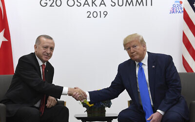Illustrative: US President Donald Trump, right, shakes hands with Turkish President Recep Tayyip Erdogan, left, during a meeting on the sidelines of the G-20 summit in Osaka, Japan, June 29, 2019. (Susan Walsh/AP)