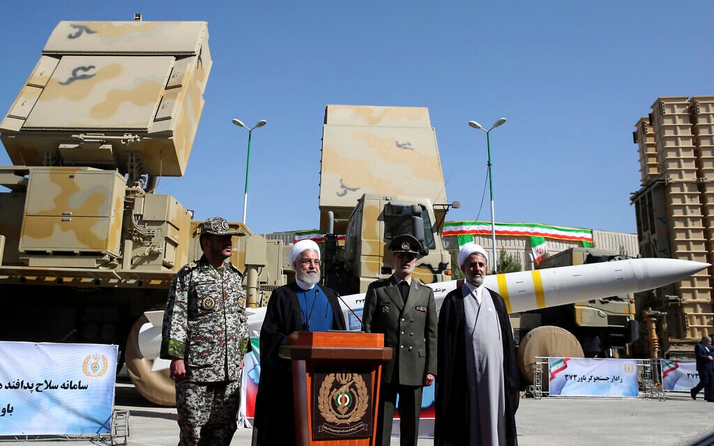 President Hassan Rouhani, second left, speaks during a ceremony to unveil the Iran-made Bavar-373, a long-range surface-to-air missile system, displayed at rear, as his Defense Minister Gen. Amir Hatami, second right, commander of army's air defense force Gen. Alireza Sabahifard, left, and the chairman of the parliament's National Security and Foreign Policy Committee Mojtaba Zolnour, listen, at an undisclosed location in Iran, August 22, 2019. (Iranian Presidency Office via AP) President Hassan Rouhani, second left, speaks during a ceremony to unveil the Iran-made Bavar-373, a long-range surface-to-air missile system, displayed at rear, as his Defense Minister Gen. Amir Hatami, second right, commander of army's air defense force Gen. Alireza Sabahifard, left, and the chairman of the parliament's National Security and Foreign Policy Committee Mojtaba Zolnour, listen, at an undisclosed location in Iran, August 22, 2019. (Iranian Presidency Office via AP)