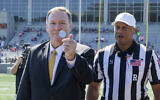 U.S. Secretary of State Mike Pompeo flips a coin to at the start of an NCAA college football game between the Army and Morgan State, Saturday, Sept. 21, 2019 in West Point, N.Y. (AP/Julius Constantine Motal)