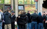 People mourn in front of a kebab grill in Halle, Germany, Thursday, October 10, 2019. (AP Photo/Jens Meyer)