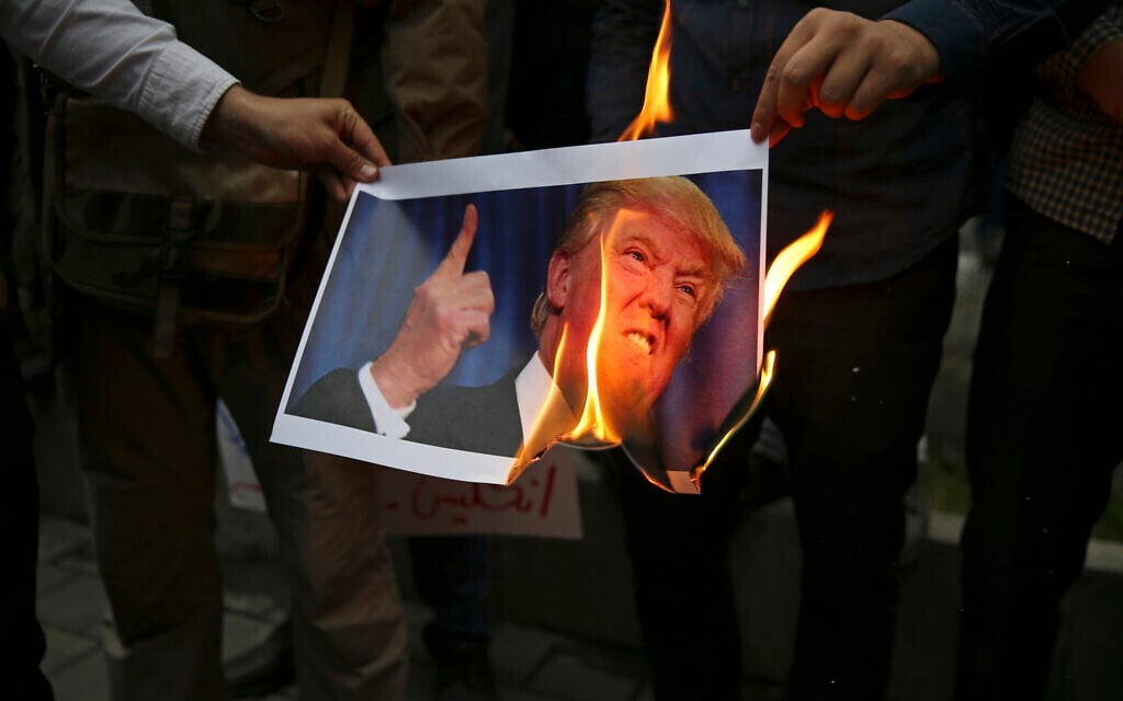 In this May 9, 2018, file photo, Iranian demonstrators burn a picture of US President Donald Trump during a protest in front of the former US Embassy in Tehran, Iran. (AP Photo/Vahid Salemi, File) In this May 9, 2018, file photo, Iranian demonstrators burn a picture of US President Donald Trump during a protest in front of the former US Embassy in Tehran, Iran. (AP Photo/Vahid Salemi, File)