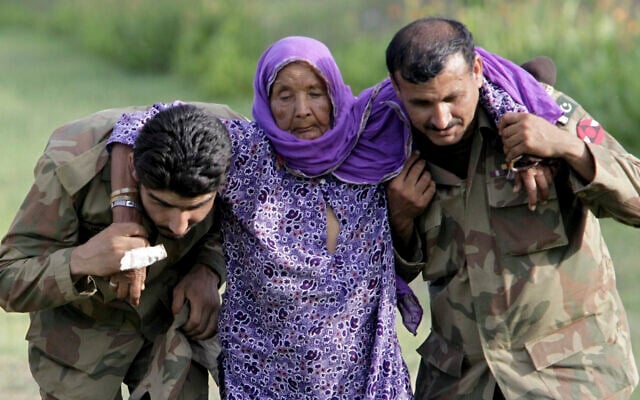 In this July 30, 2010 file photo, Pakistani army soldiers help an elderly villager evacuated from a flooded area in Nowshera, Pakistan. As Turkish forces invaded northern Syria in early October 2019, supporters of the offensive launched an online misinformation campaign. Dozens of misleading images claiming to show Turkey’s soldiers cuddling babies, feeding hungry toddlers and carrying elderly women, including this image from 2010, spread across Twitter and Instagram where they were liked, retweeted and viewed thousands of times. (AP Photo/Mohammad Sajjad, File) In this July 30, 2010 file photo, Pakistani army soldiers help an elderly villager evacuated from a flooded area in Nowshera, Pakistan. As Turkish forces invaded northern Syria in early October 2019, supporters of the offensive launched an online misinformation campaign. Dozens of misleading images claiming to show Turkey’s soldiers cuddling babies, feeding hungry toddlers and carrying elderly women, including this image from 2010, spread across Twitter and Instagram where they were liked, retweeted and viewed thousands of times. (AP Photo/Mohammad Sajjad, File)