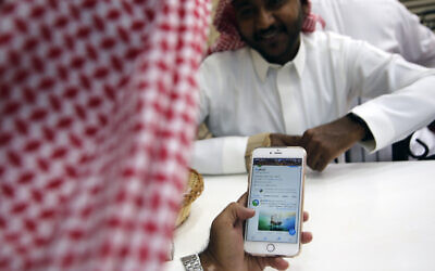 Illustrative: A man reads Twitter at a coffee shop in Jiddah, Saudi Arabia, Sunday, Nov. 3, 2019.  (AP Photo/Amr Nabil)