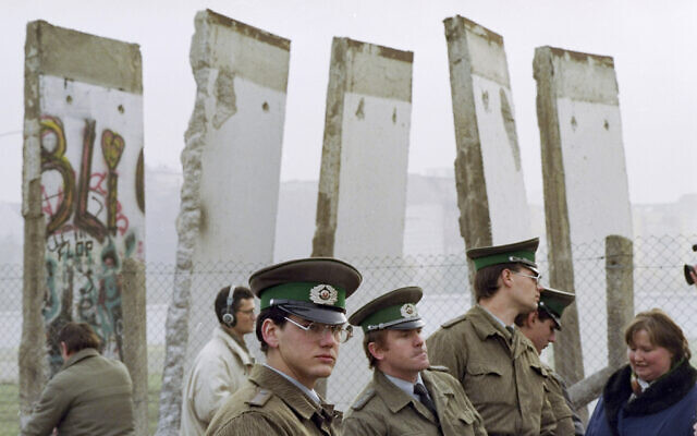 In this Nov. 13, 1989, file photo, East German border guards stand in front of segments of the Berlin Wall, which were removed to open the wall at Potsdamer Platz passage in Berlin (AP Photo/John Gaps III, File)