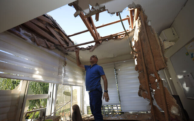A man looks at the damage to a house in Sderot, Israel, after it was hit by a rocket fired from Gaza Strip, November 12, 2019. (Tsafrir Abayov/AP) A man looks at the damage to a house in Sderot, Israel, after it was hit by a rocket fired from Gaza Strip, November 12, 2019. (Tsafrir Abayov/AP)