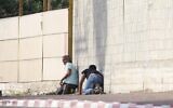 People take cover during an air-raid warning siren in Sderot, southern Israel on November 13, 2019. (AP/Ariel Schalit)