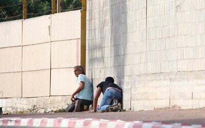 People take cover during an air-raid warning siren in Sderot, southern Israel on November 13, 2019. (AP/Ariel Schalit)