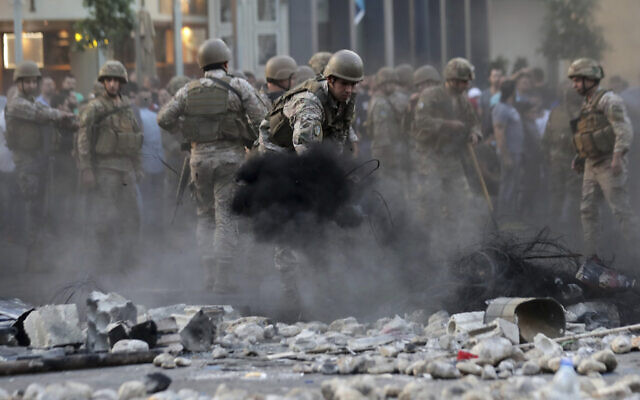 Lebanese soldiers open a blocked road followed scuffles between rival groups in the town of Jal el-Dib, north of Beirut, Lebanon, November 13, 2019. (AP Photo/Hassan Ammar) Lebanese soldiers open a blocked road followed scuffles between rival groups in the town of Jal el-Dib, north of Beirut, Lebanon, November 13, 2019. (AP Photo/Hassan Ammar)