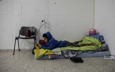 A child lies inside a bomb shelter in the coastal city of Ashkelon, Israel, amid a two-day bout of rocket fire from the Gaza Strip, November 13, 2019. (Tsafrir Abayov/AP)