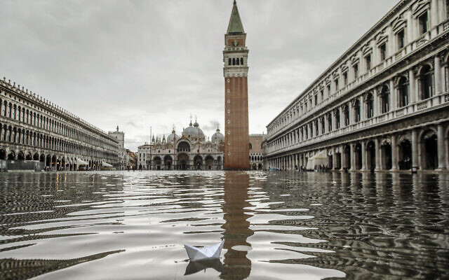 A paper boat floats in a flooded St. Mark's Square in Venice, November 15, 2019 (AP Photo/Luca Bruno) A paper boat floats in a flooded St. Mark's Square in Venice, November 15, 2019 (AP Photo/Luca Bruno)