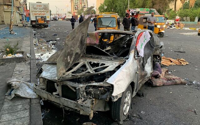 A damaged vehicle sits at the site of a bomb attack near Tahrir square in Baghdad, Iraq, Nov. 16, 2019 (AP Photo/Ali Abdul Hassan) A damaged vehicle sits at the site of a bomb attack near Tahrir square in Baghdad, Iraq, Nov. 16, 2019 (AP Photo/Ali Abdul Hassan)