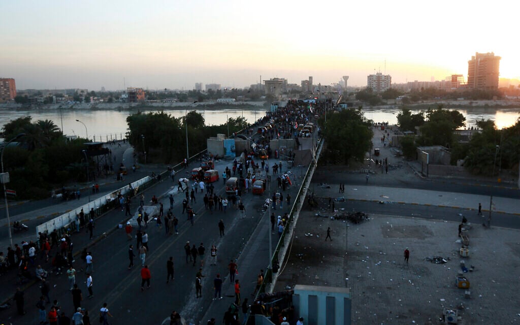 Protesters take control of some concrete walls and barriers erected by security forces to close the Sinak bridge leading to the Green Zone government areas, during clashes between Iraqi security forces and anti-government demonstrators in Baghdad, Iraq, Saturday, Nov. 16, 2019. (AP Photo/Hadi Mizban) Protesters take control of some concrete walls and barriers erected by security forces to close the Sinak bridge leading to the Green Zone government areas, during clashes between Iraqi security forces and anti-government demonstrators in Baghdad, Iraq, Saturday, Nov. 16, 2019. (AP Photo/Hadi Mizban)