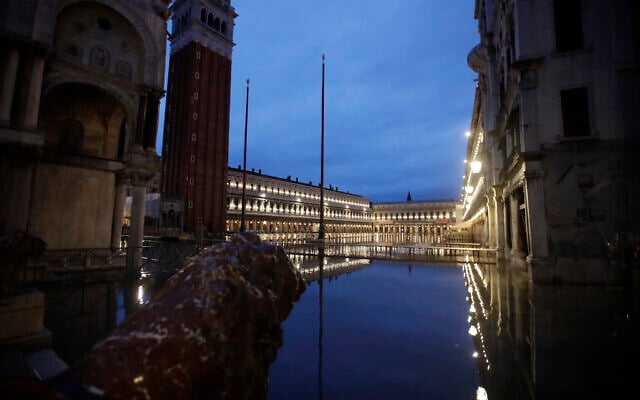 St. Mark's Square is reflected in flood water at dawn in Venice, Italy, November 17, 2019. (AP Photo/Luca Bruno)