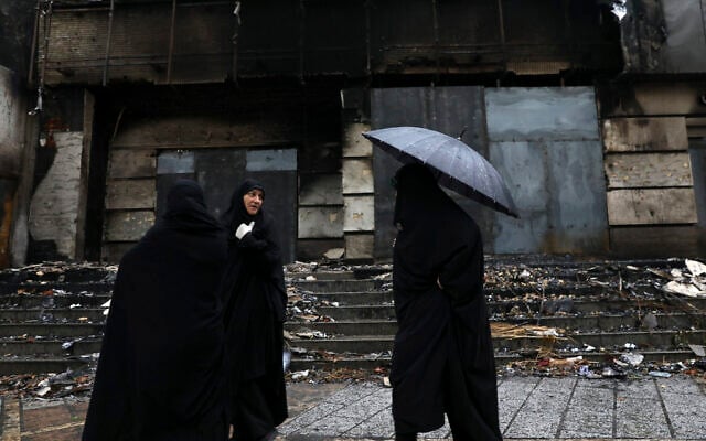 Women walk past a building damaged during recent protests, in Shahriar, Iran, some 40 kilometers (25 miles) southwest of the capital, Tehran, November 20, 2019. (AP Photo/Vahid Salemi) Women walk past a building damaged during recent protests, in Shahriar, Iran, some 40 kilometers (25 miles) southwest of the capital, Tehran, November 20, 2019. (AP Photo/Vahid Salemi)