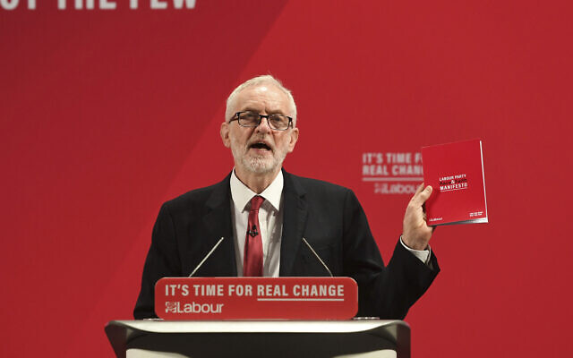 Britain's main opposition Labour Party leader Jeremy Corbyn holds a copy of the party race and faith manifesto, in London, November 26, 2019. (Joe Giddens/PA via AP) Britain's main opposition Labour Party leader Jeremy Corbyn holds a copy of the party race and faith manifesto, in London, November 26, 2019. (Joe Giddens/PA via AP)