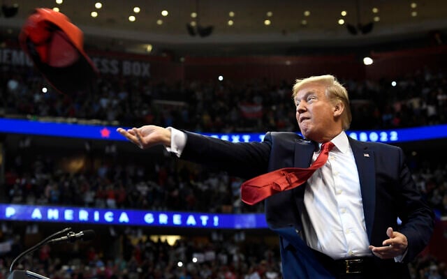 US President Donald Trump throws a hat as he arrives to speak at a campaign rally in Sunrise, Fla., Tuesday, Nov. 26, 2019. Trump will join the rest of his family and spend the Thanksgiving holiday at his Mar-a-Lago estate. (AP Photo/Susan Walsh) US President Donald Trump throws a hat as he arrives to speak at a campaign rally in Sunrise, Fla., Tuesday, Nov. 26, 2019. Trump will join the rest of his family and spend the Thanksgiving holiday at his Mar-a-Lago estate. (AP Photo/Susan Walsh)
