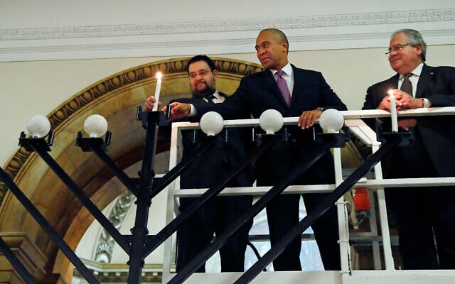 From left, Rabbi Rachmiel Liberman, then Massachusetts Governor Deval Patrick and Massachusetts House Speaker Robert DeLeo light candles on an 18-foot menorah to mark the arrival of Hanukkah during a ceremony at the Statehouse in Boston, December 16, 2014. (AP Photo/Elise Amendola) From left, Rabbi Rachmiel Liberman, then Massachusetts Governor Deval Patrick and Massachusetts House Speaker Robert DeLeo light candles on an 18-foot menorah to mark the arrival of Hanukkah during a ceremony at the Statehouse in Boston, December 16, 2014. (AP Photo/Elise Amendola)