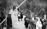 German refugee passing the Russian barrier to move east from the American zone at Gros Topfer, the exchange point, on November 6, 1945. (AP Photo)