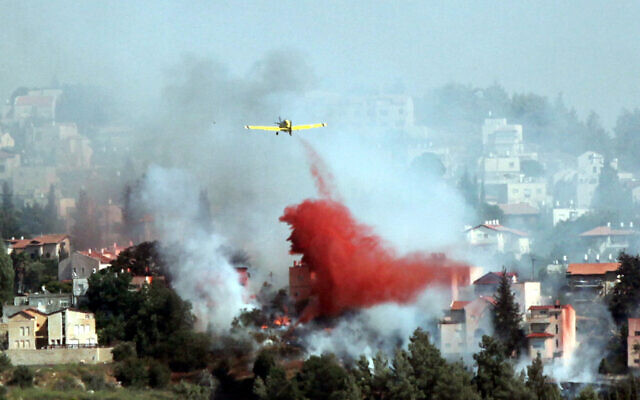 Illustrative: Airplanes and firefighters try to extinguish a forest fire which raged in Mevaseret Zion, just outside of Jerusalem. July 15, 2012. (Yossi Zamir/Flash 90) Illustrative: Airplanes and firefighters try to extinguish a forest fire which raged in Mevaseret Zion, just outside of Jerusalem. July 15, 2012. (Yossi Zamir/Flash 90)