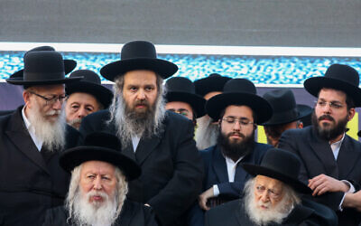 Yaakov Litzman, left, and Rabbi Yaakov Aryeh Alter of the Gur Hassidic Dynasty, second left, attend a rally of United Torah Judaism party in Jerusalem, April 8, 2019.  Noam Revkin Fenton/Flash90)