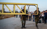 Israeli soldiers close the gate leading to the "Isle of Peace" at Naharayim on November 9, 2019. (Basel Awidat/Flash90)