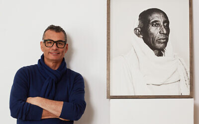 Photographer John Offenbach in front of one of his subjects at his London Jewish Museum exhibition, 'Jew.' (Courtesy)