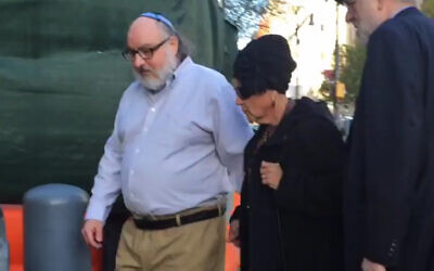 Jonathan Pollard, left, arrives at a federal courthouse in New York with his wife, Esther, to check in at a probation office just hours after he was released from prison, November 20, 2015. (Ilana Gold/WCBS-TV via AP Images/via JTA)