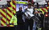 Police assist an injured man near London Bridge in London, on November 29, 2019 after a terror stabbing in the area. (Daniel Sorabji/AFP)
