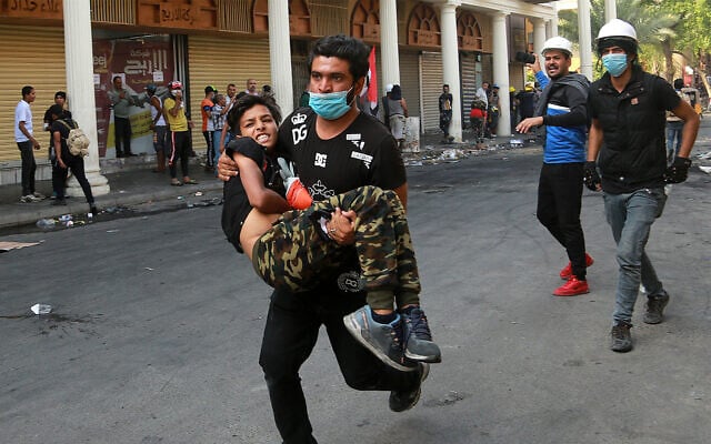 An injured protester is rushed to a hospital during clashes between Iraqi security forces and anti-government protesters in central Baghdad, Iraq, November 7, 2019. (AP Photo/Hadi Mizban) An injured protester is rushed to a hospital during clashes between Iraqi security forces and anti-government protesters in central Baghdad, Iraq, November 7, 2019. (AP Photo/Hadi Mizban)