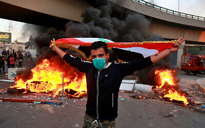 An anti-government protester near the prime minister's office and state-run TV in Baghdad, Iraq, November 4, 2019. (AP Photo/Khalid Mohammed)